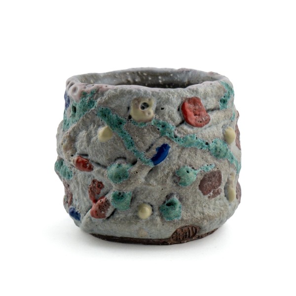 Handmade gray ceramic tea cup with textured surface and color speckles by Yukihisa